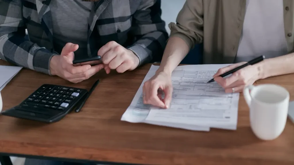 Couple reviewing household bills and ways to lower their electric bill