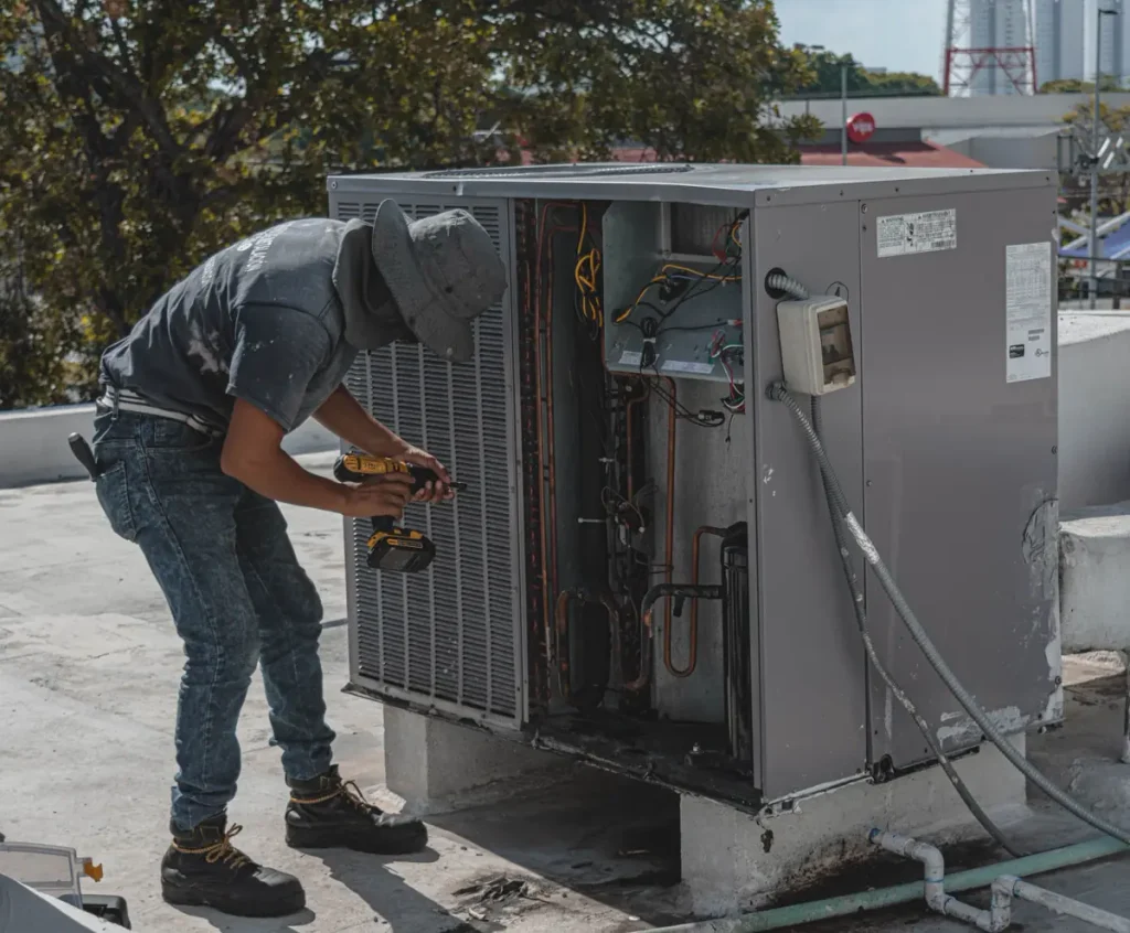 HVAC technician checking equipment that may cause a high electric bill